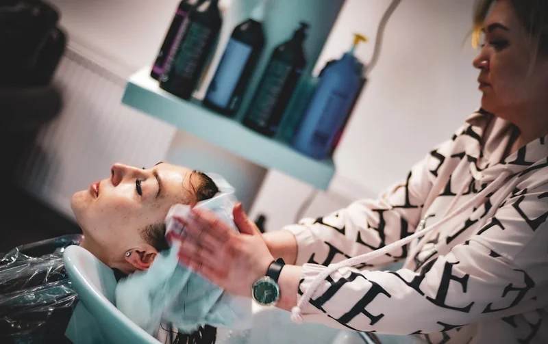 a man getting his hair washed in a salon
